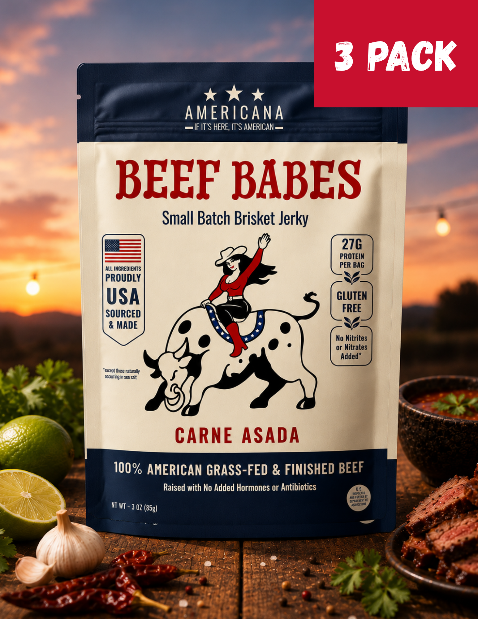 A 3-pack bag of Americana Beef Babes Carne Asada small batch brisket jerky, displayed on a rustic wooden table with raw ingredients (lime, garlic, chili peppers) and cooked meat slices, set against a warm sunset background with a red '3 PACK' banner overlay.