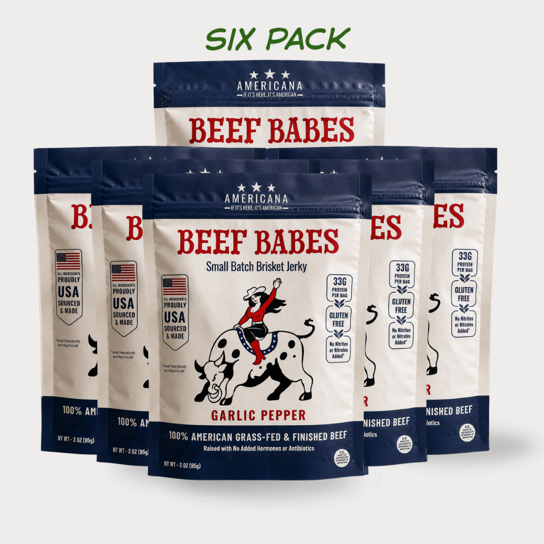 Six bags of Americana Beef Babes Small Batch Brisket Jerky in Garlic Pepper flavor, arranged in a 3x2 grid on a light gray background with a green 'SIX PACK' text overlay at the top.