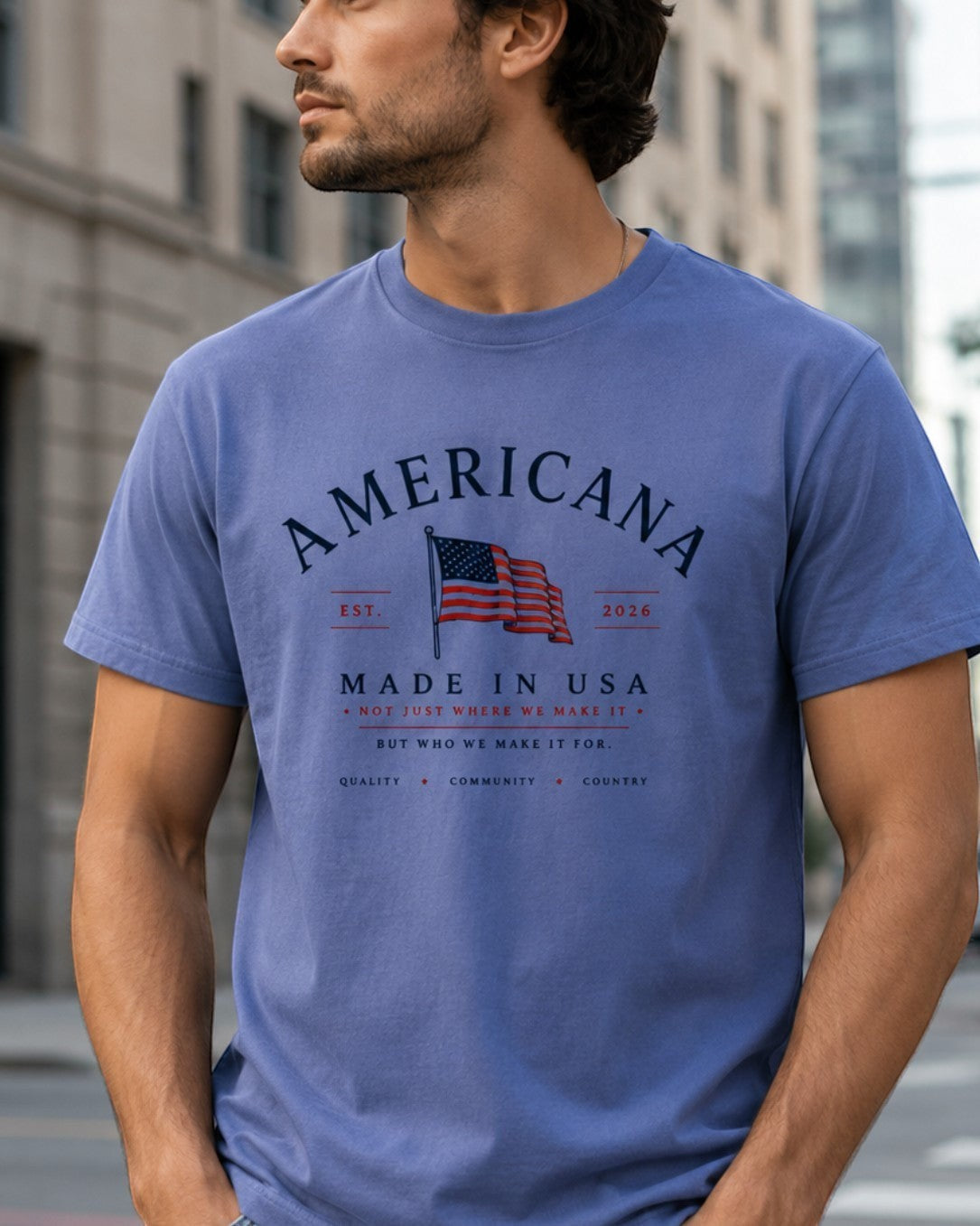 Americana tri-blend t-shirt in blue with a Made in USA graphic print worn by a man in an urban setting.