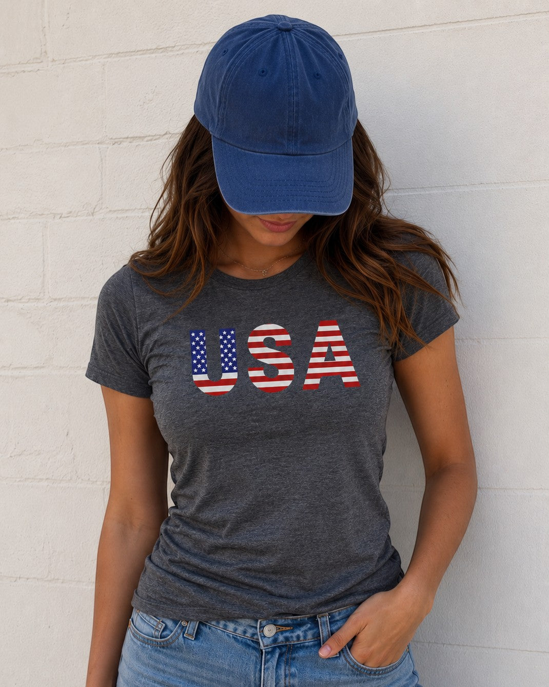 Americana charcoal heather crewneck t-shirt with USA stars and stripes graphic worn by a woman in a blue baseball cap